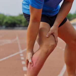 Person oplever muskelsmerter i benet efter fysisk aktivitet og belastning.